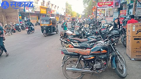Two-wheelers parked on both sides of the road leading to the old bus stand here.