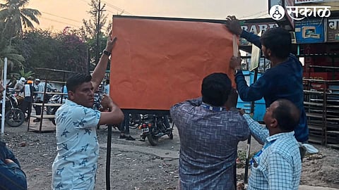 Municipal Corporation employees covering political placards in various parts of the city as the Lok Sabha Election Code of Conduct came into effect.