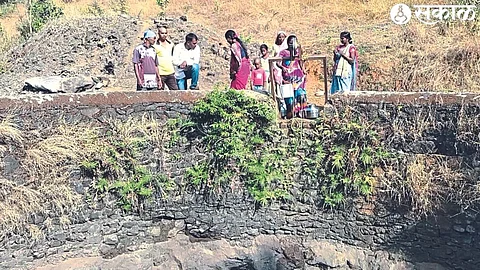 Women drawing water from a well.