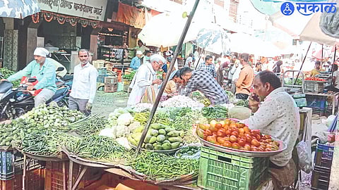 Consumers while buying vegetables in the market.