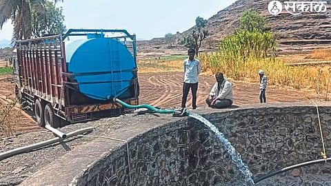 The water being released in the Gram Panchayat well here with the help of a tanker.