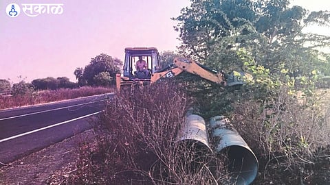 JCB removing thorn bushes on Chimthane-Shindkheda state road in Gavshivar on Monday.