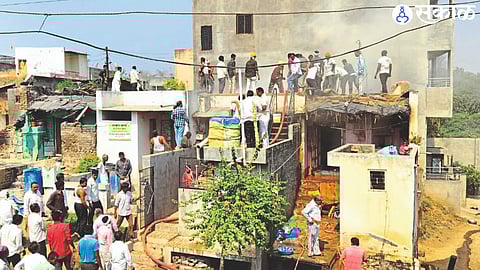 Firefighters and villagers extinguishing house fires.