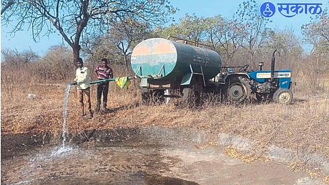 Forest department staff while filling the artificial water bodies in the forest with the help of tankers.