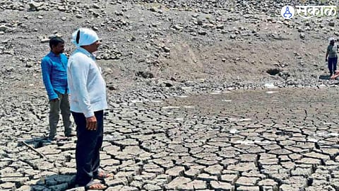 Tushar Mahale, Vikas Jadhav, Deva Pakle looking at a place to carve a pit for water in the dry Lalbardi dam.