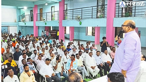 Guardian Minister Gulabrao Patil speaking at the Shiv Sena Shinde group meeting. Officials and activists in front.