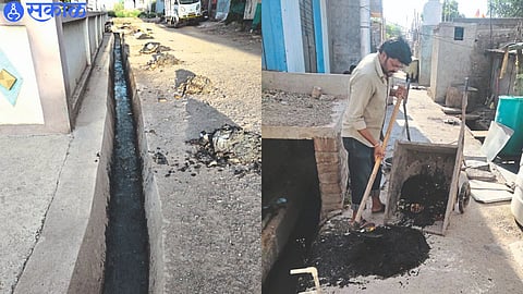 Sewers cleaned in city, Sanitation workers scooping garbage from sewers