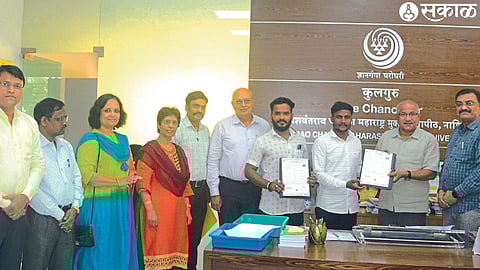 Vice-Chancellor Dr. Yashwantrao Chavan while distributing block chain-based QR code marked mark sheets to students who passed the examination of Maharashtra Open University.