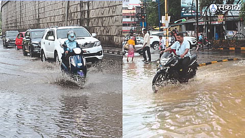 Vehicles passing through rain water on the road.