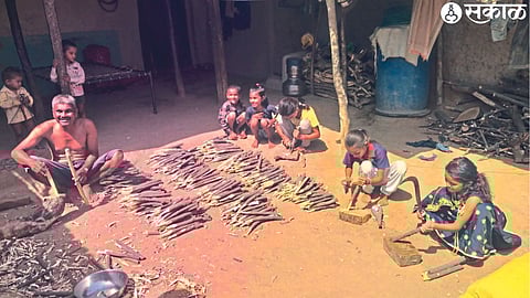 Farmers here making wooden pegs for drip irrigation.