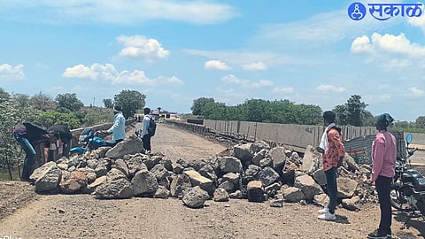 The road has been blocked by throwing big stones on both sides of the bridge.