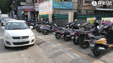 Two-wheelers parked on footpaths from Meher Signal to Ashokastambh Smart Road. And unauthorized parking of four-wheelers along the footpath.