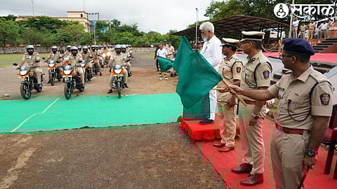 Guardian Minister Dada Bhuse flagging off the new 75 two-wheelers made available for patrolling at the Nashik Rural Superintendent of Police office in Adgaon.