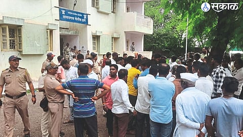 A crown made by relatives outside the police station in Lasalgaon.