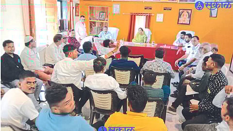 Officials and villagers present in the auction process.