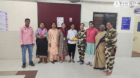 Female staff members of Nirbhaya and Damini team handing out compass boxes to schoolgirls