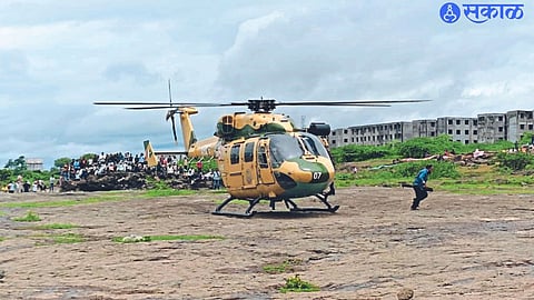 Fishermen trapped in floods of Girna river exiting the helicopter after being safely rescued.