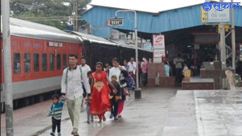The rush of passengers to board the train in the rain
