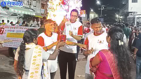 Officials of Sri Ganesh Mookbadhir Mitra Mandal giving information about the procession to family members and colleagues in sign language.