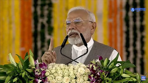 PM Narendra Modi speaking at the Vishwakarma Scheme event in Wardha, highlighting traditional skills and economic development projects.