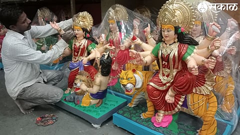 Artisans putting the final touches on the goddess idol.