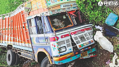 A truck overturned in a drain while avoiding a pothole on Shendurni (Jamner) road.