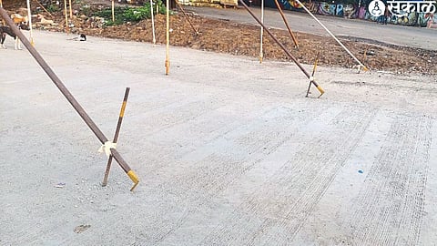 Pegs and broken concrete for pavilions on the new concrete road in the city.