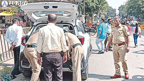 Police inspector Anil Bhaware and staff while city police seized cash from the same vehicle during the blockade.