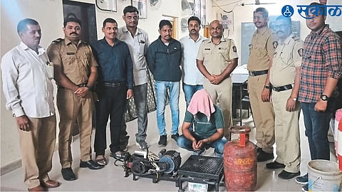 Suspect along with seized material and police team.