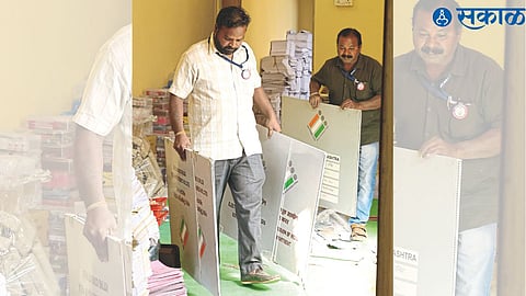 Staff carrying voting materials.