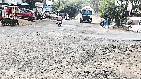 A truck blowing dust in a broken intersection on the main road.