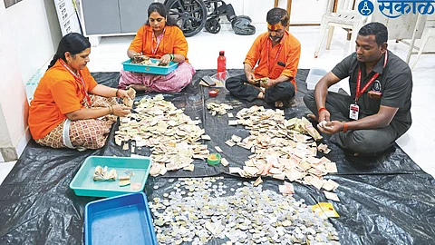Officers and staff counting the cash after opening the fourth donation box at Kapaleswar temple
