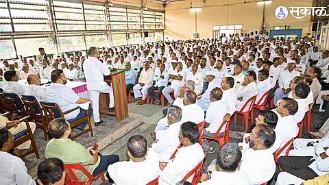 Balasaheb Patil addressing the gathering, urging members to stay proud and vigilant in his latest political speech.