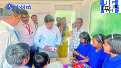 District Collector Santosh Patil interacts with students at a Zilla Parishad school, discussing their educational experiences and future goals."
