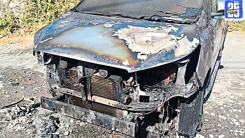 Firefighters quickly contain the blaze that destroyed two cars, preventing the fire from spreading further."