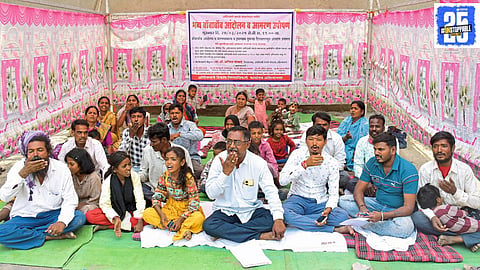 Adivasi protesters outside the District Collectorate demanding justice against an alleged conspiracy to evict families.