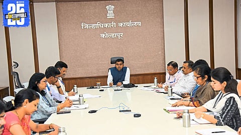 District Collector interacting with officials, emphasizing speedy execution of central government schemes.