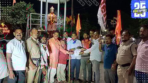 Prahar activists march with torches demanding justice and loan waiver for distressed farmers.