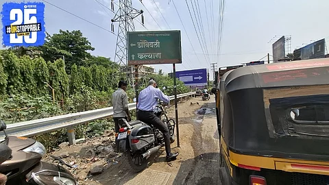 "Two-wheeler riders riskily squeezing under nameplates to beat traffic on congested Kalyan-Shil Road."