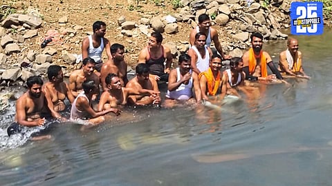 Farmers protest half-naked inside canal demanding water; agitation paused after written promise.