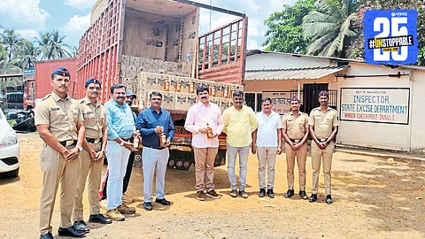 Excise officials inspecting the seized liquor consignment worth ₹39 lakh at Insuli checkpoint.