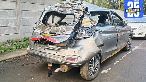 Scene from Malkapur accident where a private bus collided with a car being towed, injuring three people.