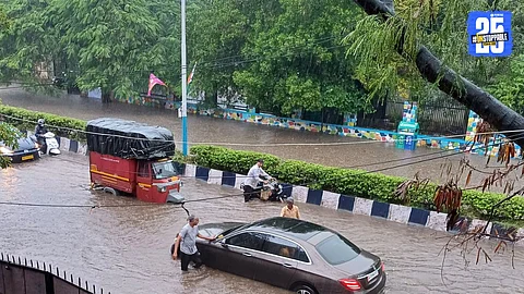 Flood-like situation on Pune streets after heavy pre-monsoon showers; residents and vehicles struggle to navigate waterlogged roads.
