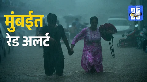 Commuters wade through a severly waterlogged road at Malabar Hill area following heavy rainfall, at Bhagwandas Indrajeet Road in Mumbai on Monday. (ANI Photo)