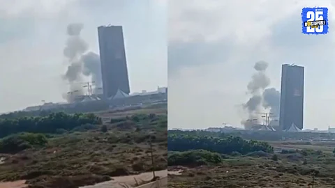 An aerial view of smoke rising from a heavily guarded area in Tel Aviv following Iran’s reported missile strike on Mossad’s headquarters amid escalating tensions.