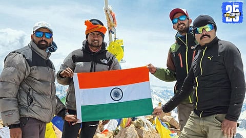 Marathi mountaineering team proudly holding the national flag after conquering Mount Yunam.
