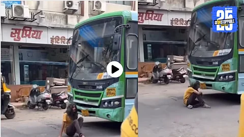 A man wearing a wig sits in front of a PMPL bus in Pune, blocking its path for an Instagram reel. The bizarre act has gone viral on social media, raising road safety concerns