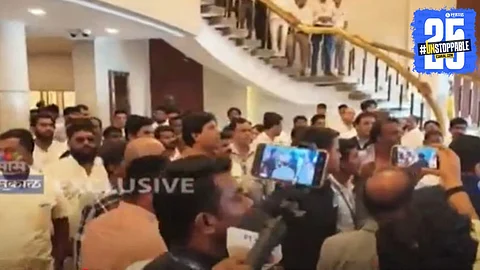 Security personnel intervene as supporters of Gopichand Padalkar and Jitendra Awhad clash in the lobby of Maharashtra Vidhan Bhavan.