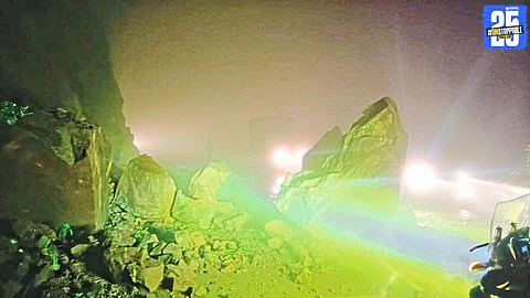 Massive landslide in Karul Ghat halts vehicular movement; rescue teams clear debris from the road.