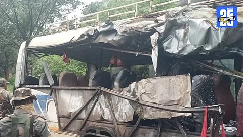 Rescue workers and locals gather around the wrecked bus after a fatal collision with a gas cylinder-loaded truck near Jamuniya in Deoghar, Jharkhand; 18 devotees killed in the tragic incident.
